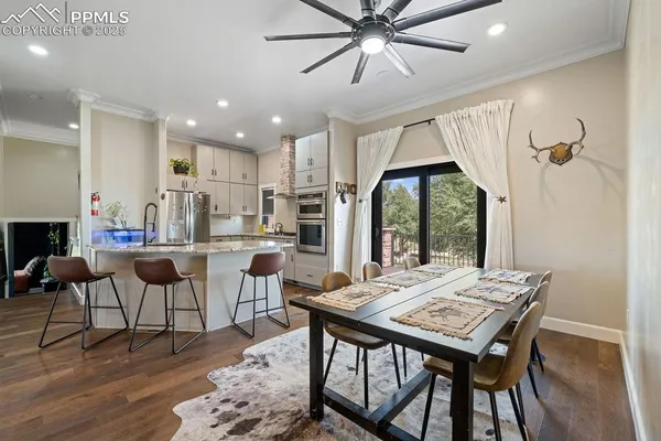 a kitchen with stainless steel appliances granite countertop a sink a stove and a refrigerator