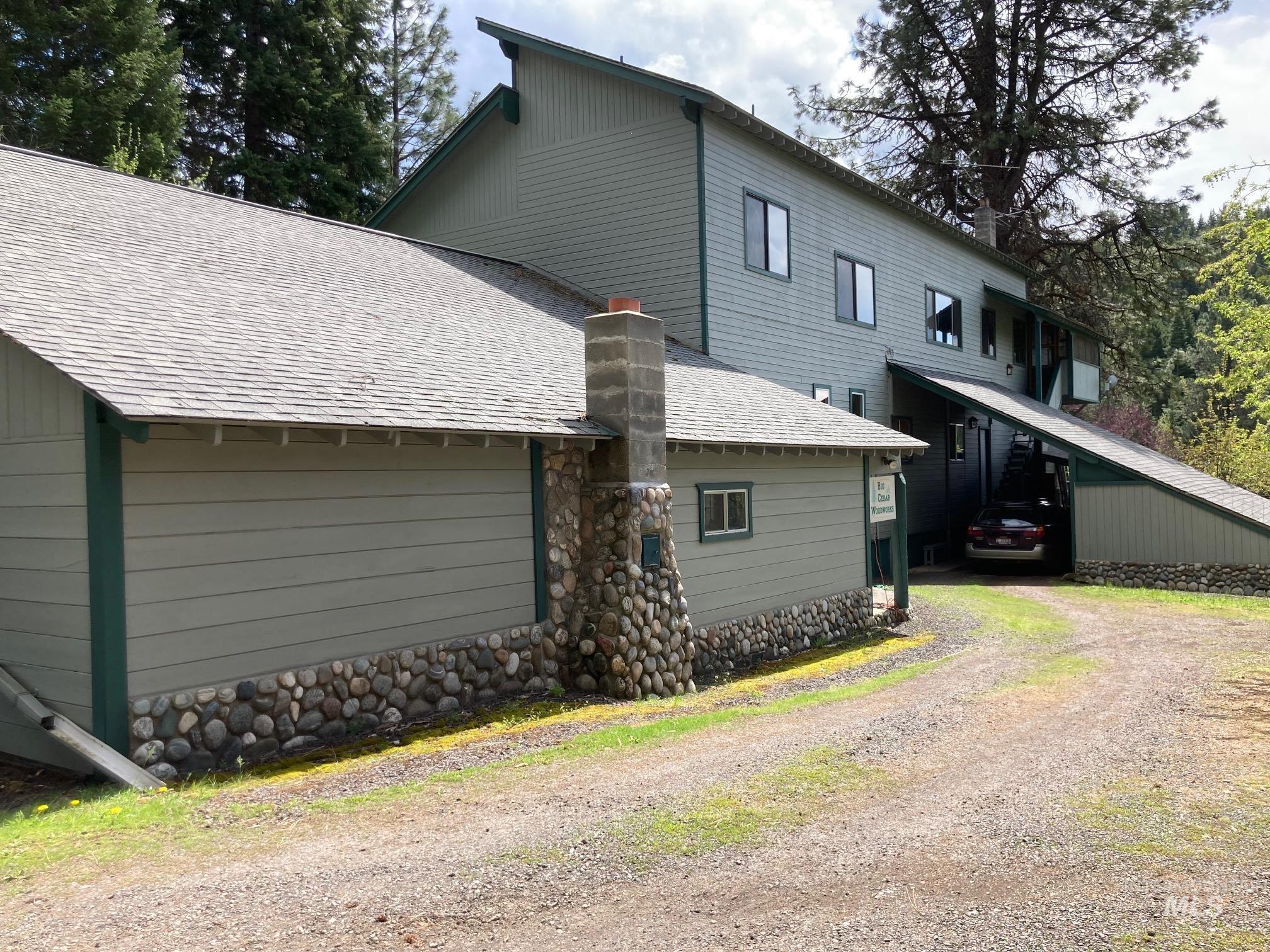 Multi-level property exterior featuring horizontal siding and stone veneer accents