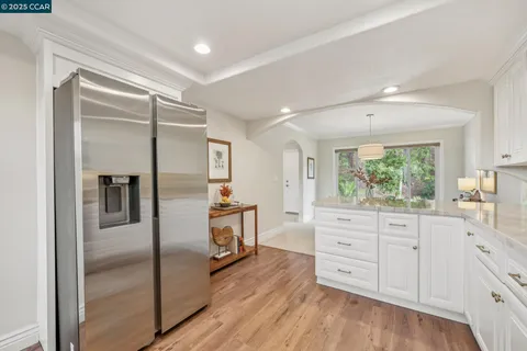 a kitchen with stainless steel appliances a refrigerator sink and cabinets