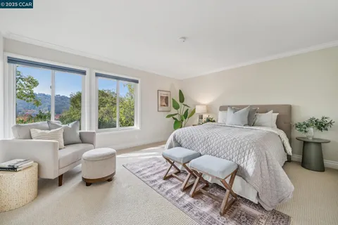 a spacious bedroom with a bed and glass window