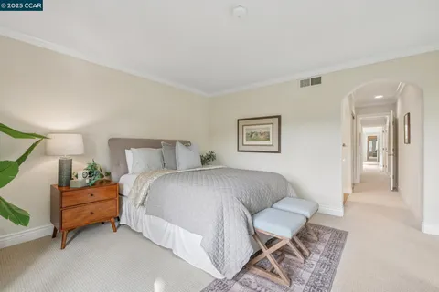 a bedroom with a bed and a chair