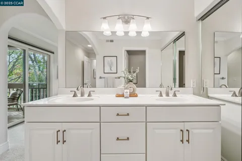 a bathroom with 2 sink and a mirror