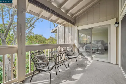 a view of a chairs and table in a balcony