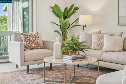 a living room with furniture flowerpot and a window