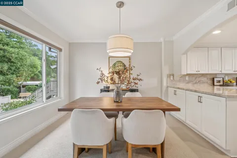 a view of a dining room with furniture window and outside view