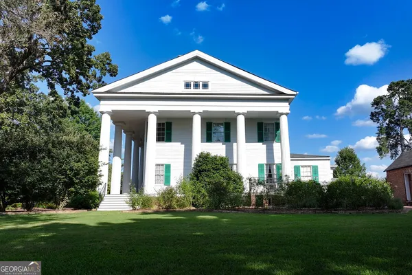an aerial view of a house with a yard