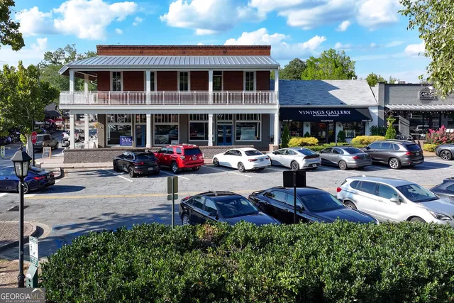 a view of a patio with table and chairs potted plants and a fountain