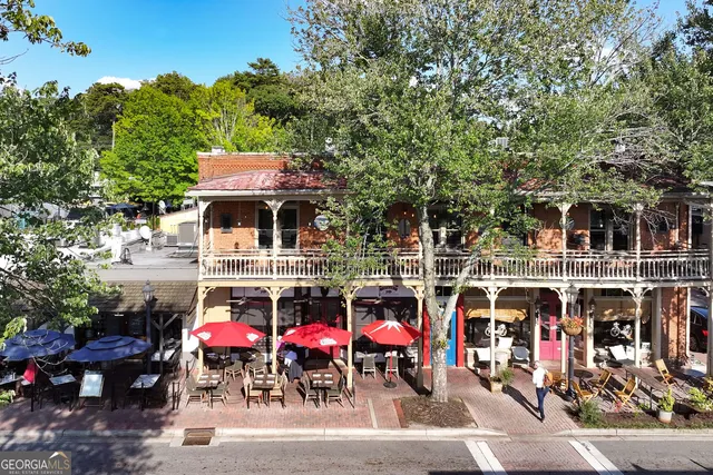 a view of a house with swimming pool and sitting area