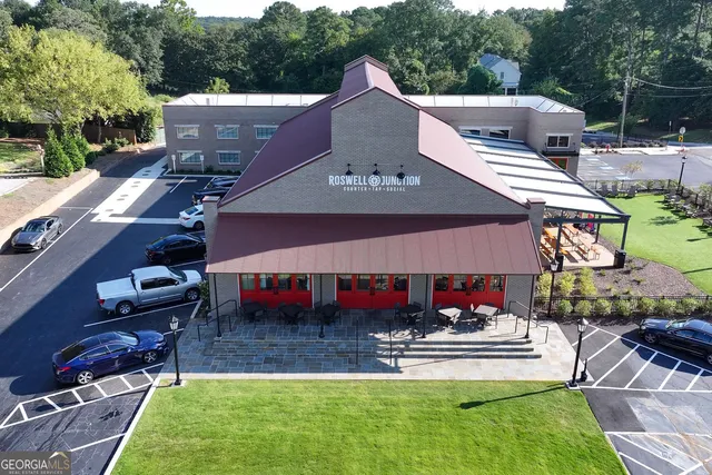 a front view of a house with a garden and patio