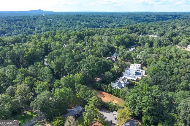 an aerial view of a house with a yard