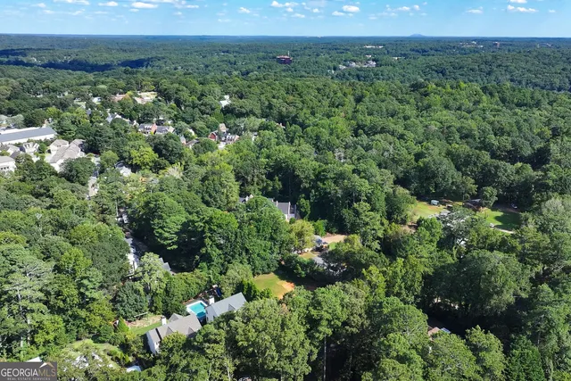 an aerial view of a houses with a yard