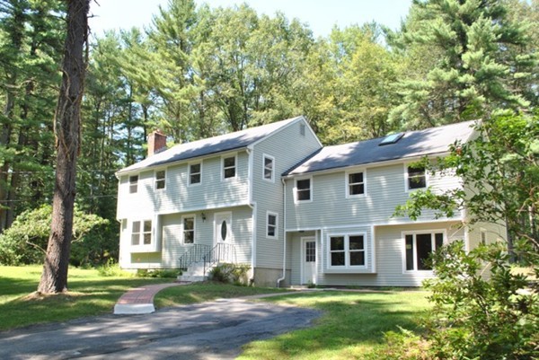 54 Judy Farm Road Carlisle, MA 01741 - Photo 1 of 17 a front view of a house with a yard