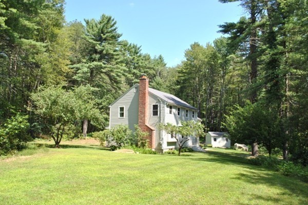 54 Judy Farm Road Carlisle, MA 01741 - Photo 14 of 17 a front view of a house with a garden