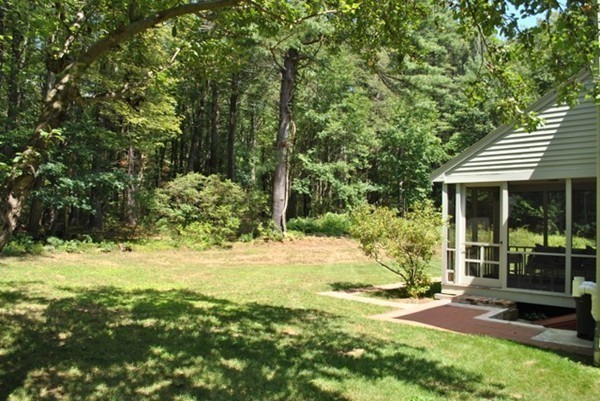 54 Judy Farm Road Carlisle, MA 01741 - Photo 15 of 17 a view of a backyard with table and chairs and potted plants