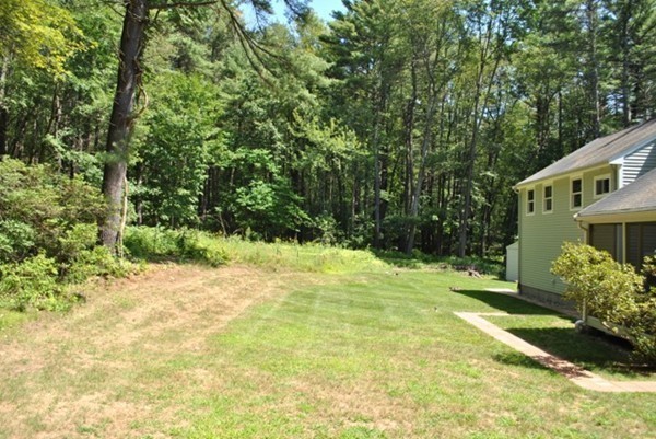54 Judy Farm Road Carlisle, MA 01741 - Photo 16 of 17 a yellow house with trees in front of it