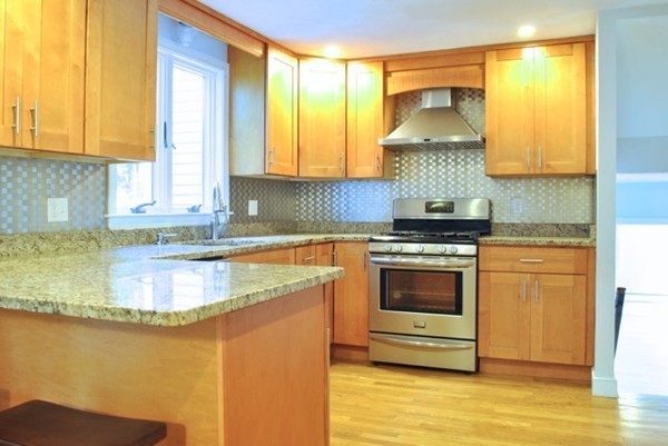 54 Judy Farm Road Carlisle, MA 01741 - Photo 5 of 17 a kitchen with stainless steel appliances granite countertop a sink a stove and a microwave