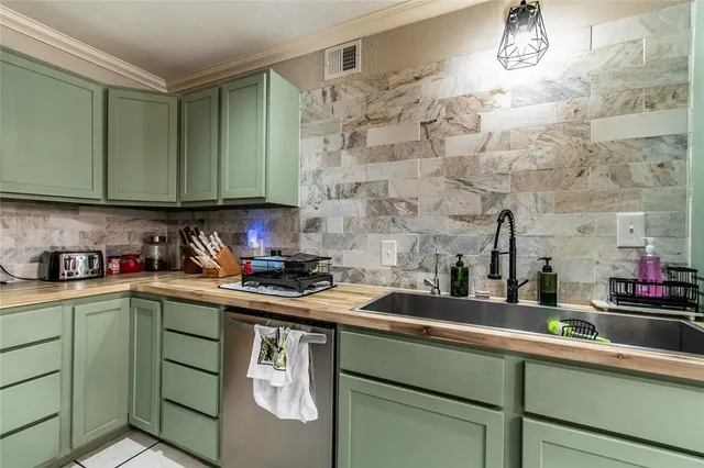 a kitchen with stainless steel appliances granite countertop a sink and cabinets