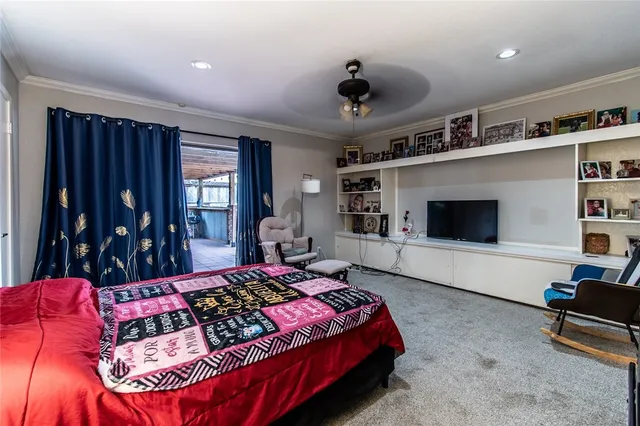 a living room with furniture ceiling fan and a flat screen tv