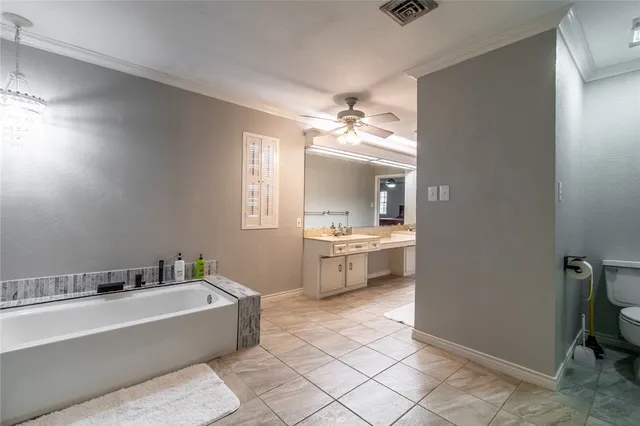 a bathroom with a tub sink and mirror