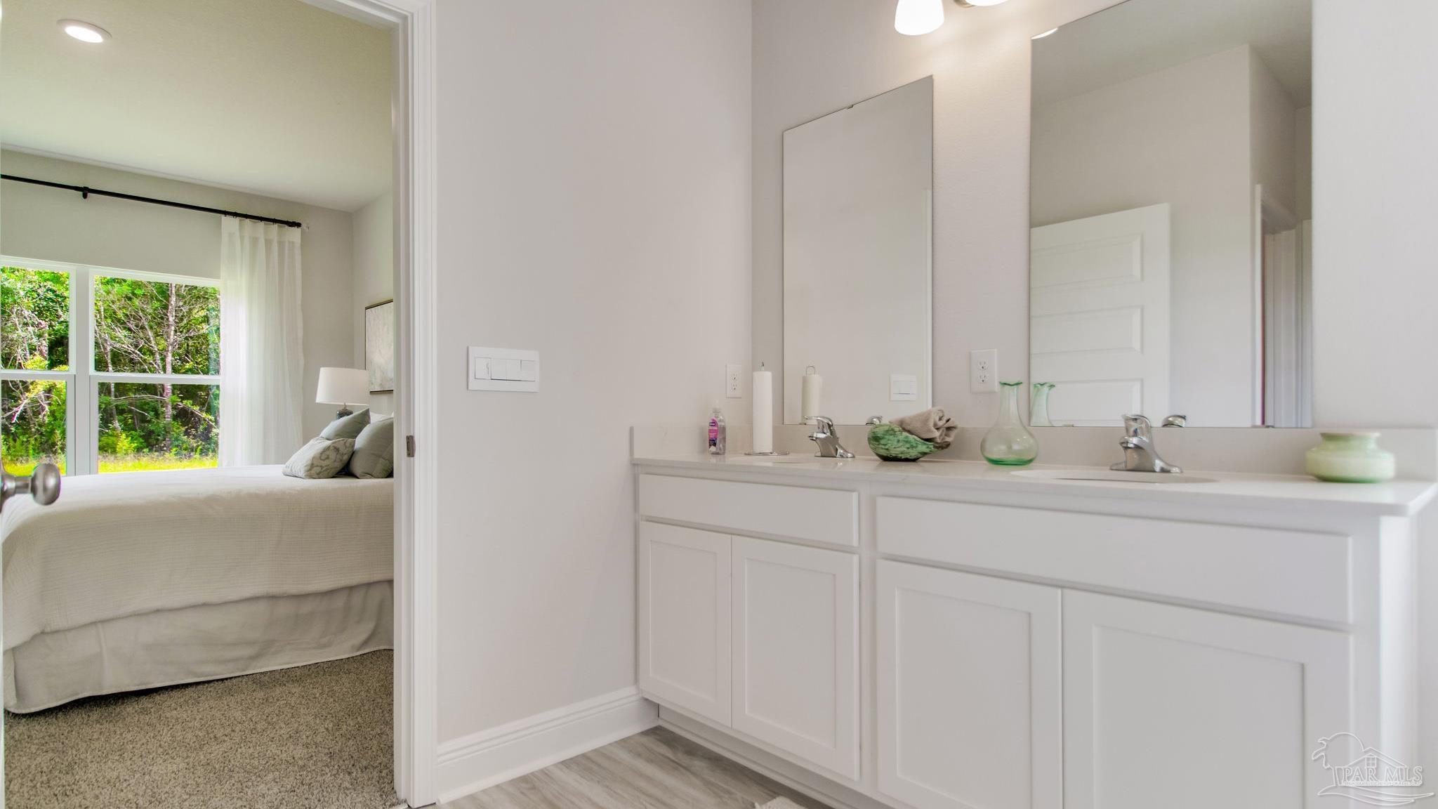 2653 Chevy Circle Pace, FL 32571 - Photo 12 of 31 a en suite bathroom with 2 sink and a mirror