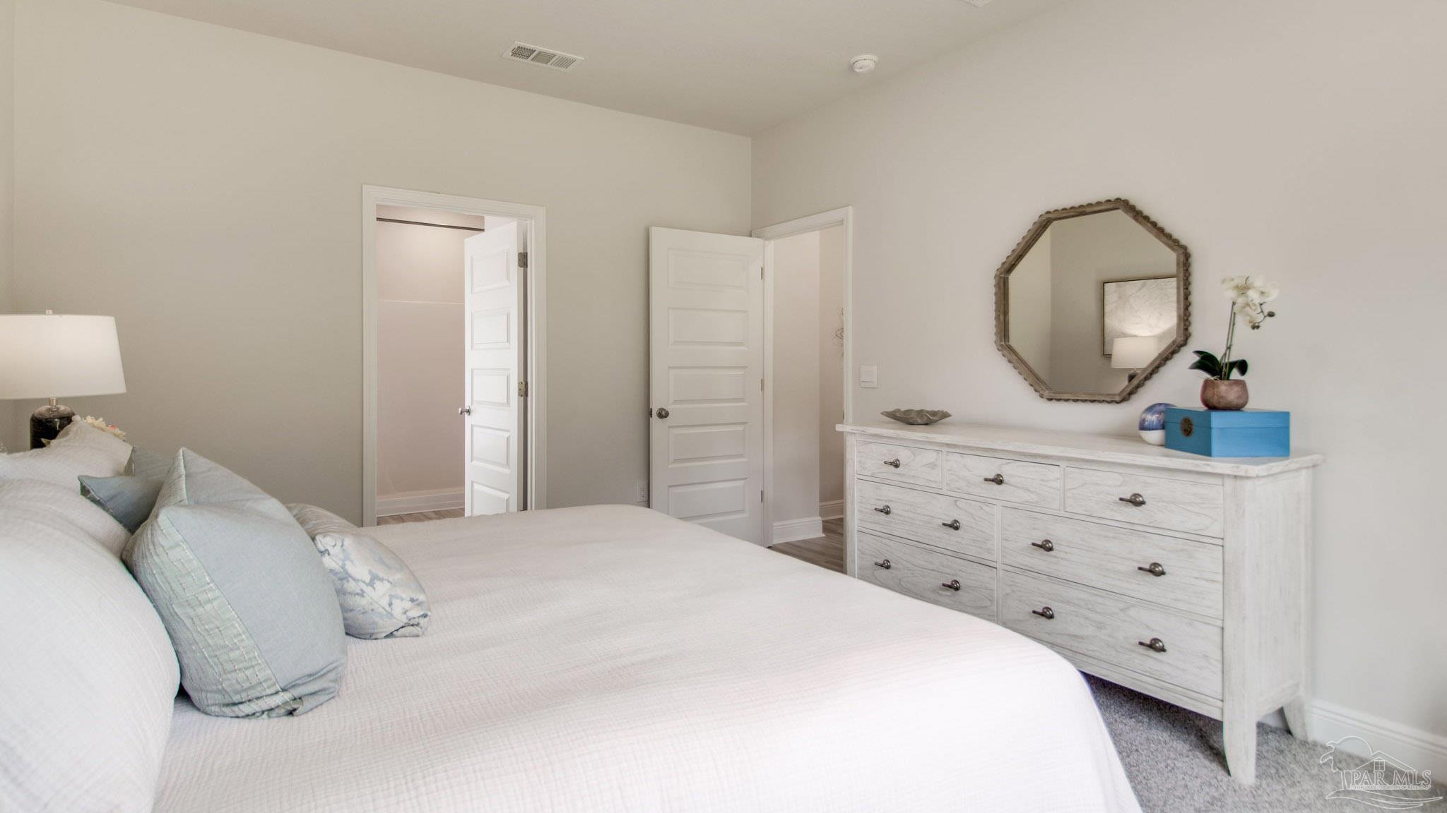 2653 Chevy Circle Pace, FL 32571 - Photo 8 of 31 a bedroom with a bed and a dresser