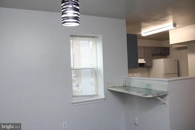 a kitchen with cabinets appliances a sink and a counter top space