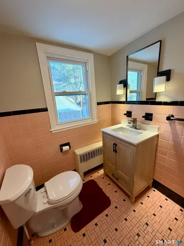 a bathroom with a sink toilet and mirror