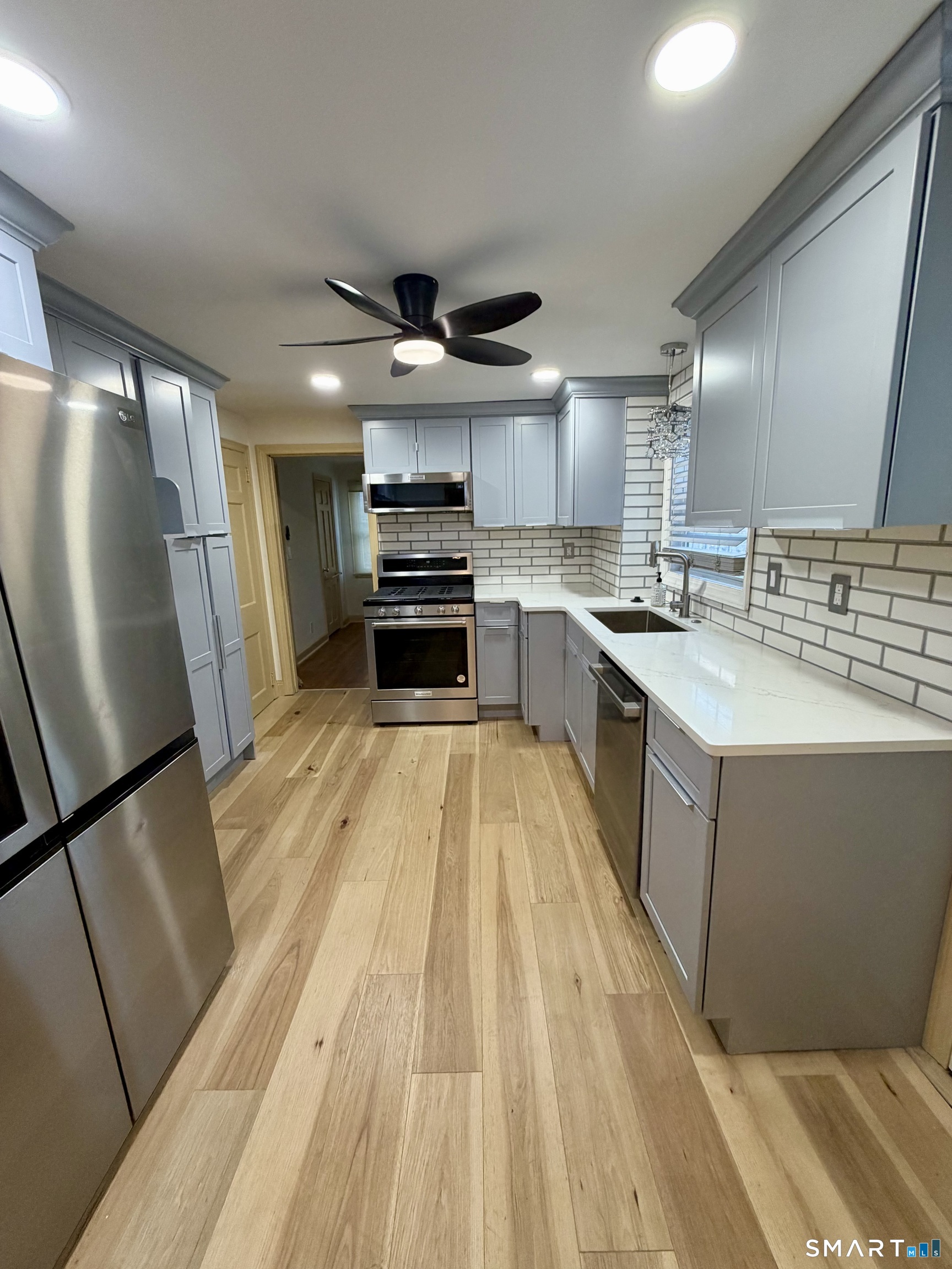 40 Nepaug Street Hartford, CT 06106 - Photo 3 of 19 a large kitchen with a sink a counter top space stainless steel appliances and cabinets