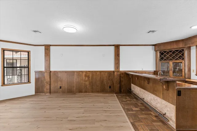 a view of a kitchen with a sink and cabinets