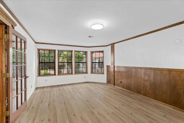a view of a livingroom with wooden floor and stairs