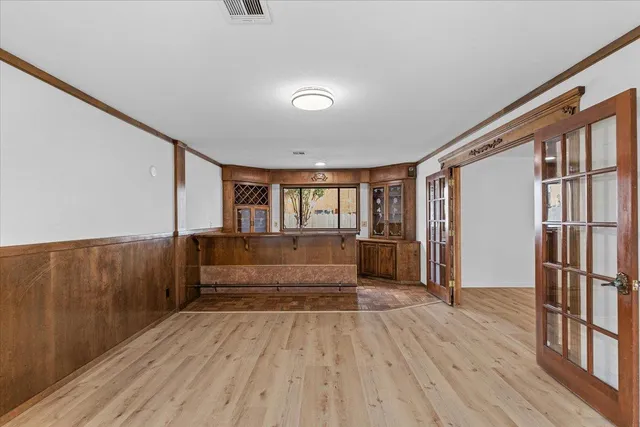 a view of empty room with wooden floor and fireplace