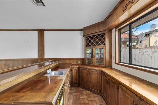 a kitchen with a sink stove and cabinets