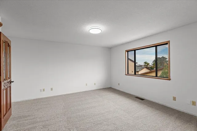 a kitchen with stainless steel appliances granite countertop a refrigerator a stove and a sink with wooden floor