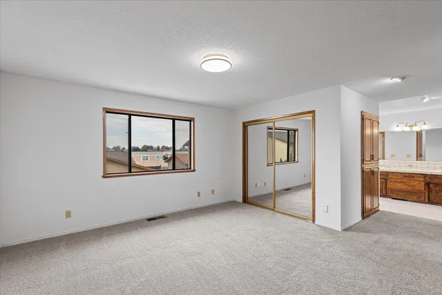 a view of a room with a ceiling fan and a window