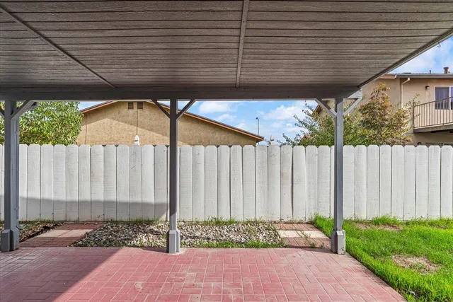 an empty room with windows and ceiling fan