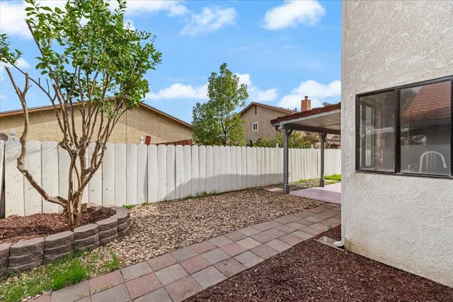a front view of a house with a garden and plants