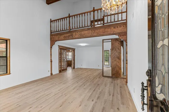 a view of a kitchen with kitchen island a sink wooden floor and black wooden floor