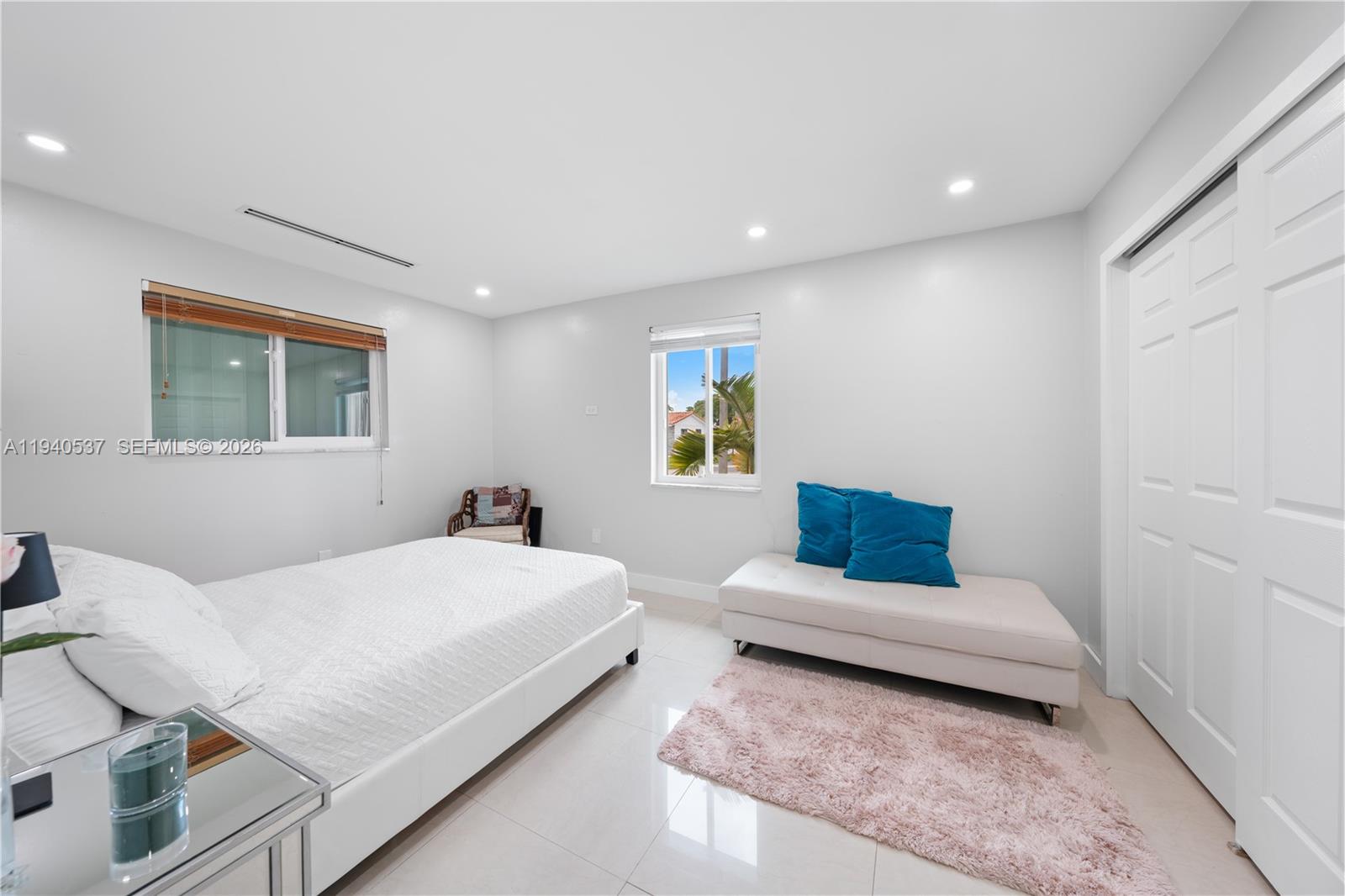 6423 Southwest 107th Place Miami, FL 33173 - Photo 20 of 37 a bedroom with a bed and glass window