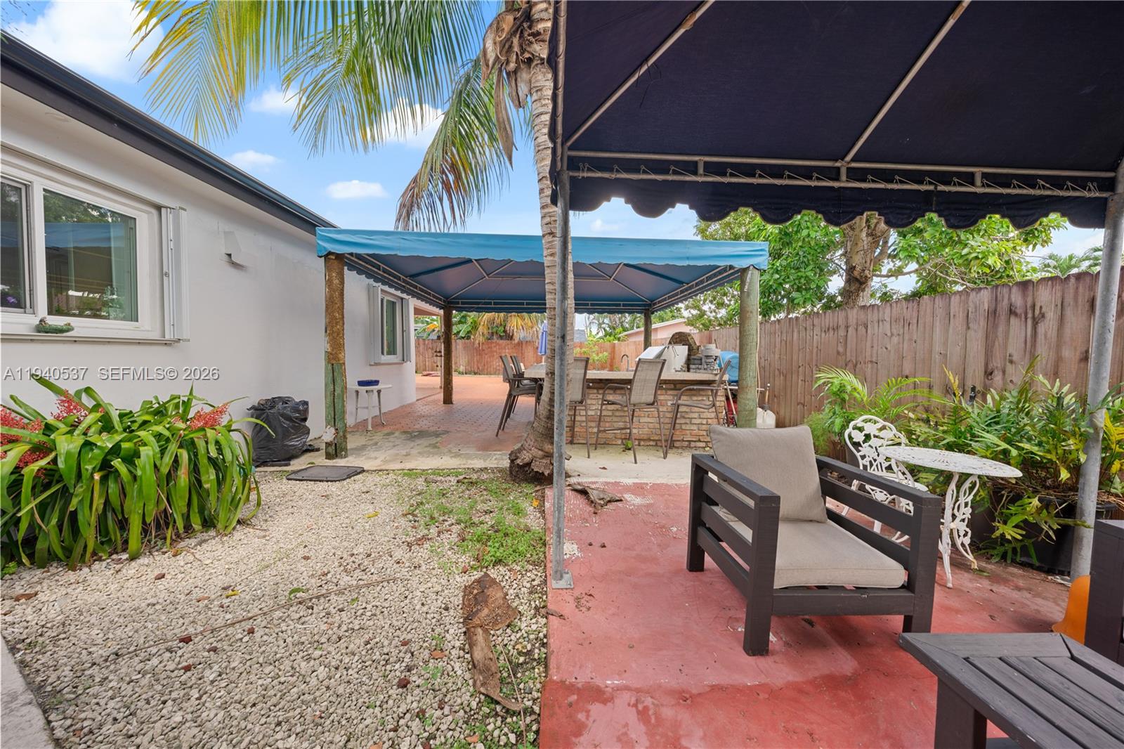6423 Southwest 107th Place Miami, FL 33173 - Photo 28 of 37 a patio with a patio table and chairs