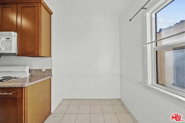 a view of a kitchen with white cabinets