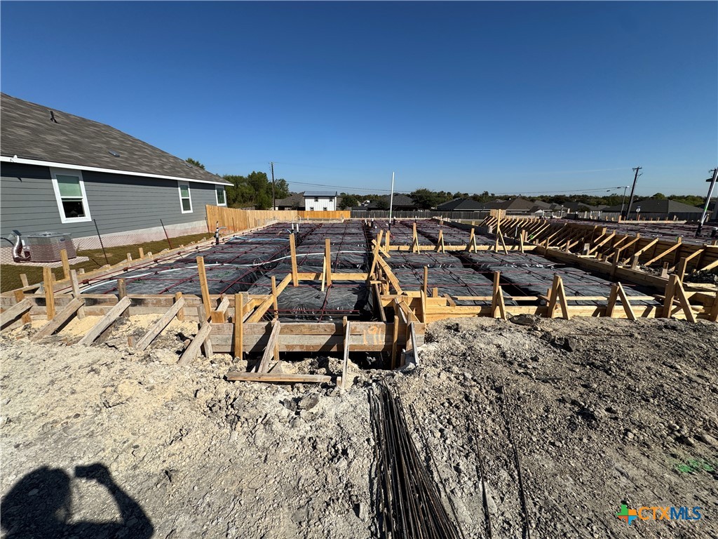 a view of a chairs and table in the backyard