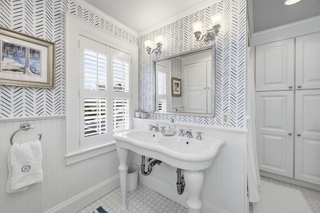 16 Pickwick Road Marblehead, MA 01945 - Photo 20 of 30 a bathroom with a sink a mirror and a window