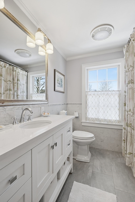 16 Pickwick Road Marblehead, MA 01945 - Photo 25 of 30 a bathroom with a granite countertop sink mirror vanity and a toilet