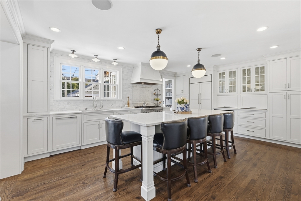 16 Pickwick Road Marblehead, MA 01945 - Photo 7 of 30 a kitchen with stainless steel appliances kitchen island granite countertop a table chairs sink and cabinets