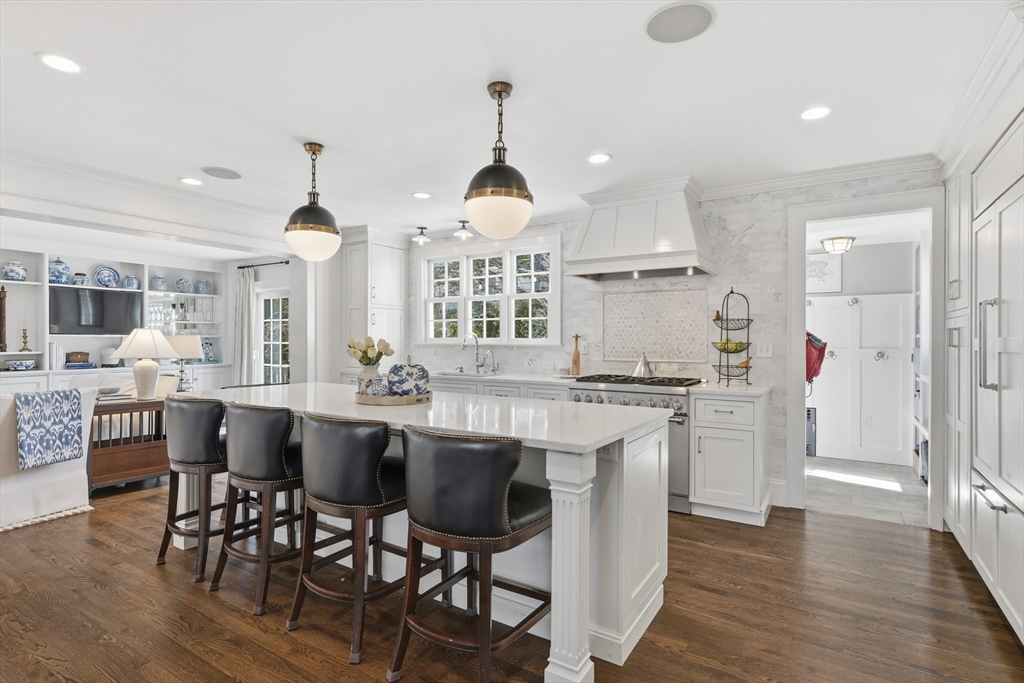 16 Pickwick Road Marblehead, MA 01945 - Photo 8 of 30 a kitchen with stainless steel appliances a dining table chairs and wooden floor