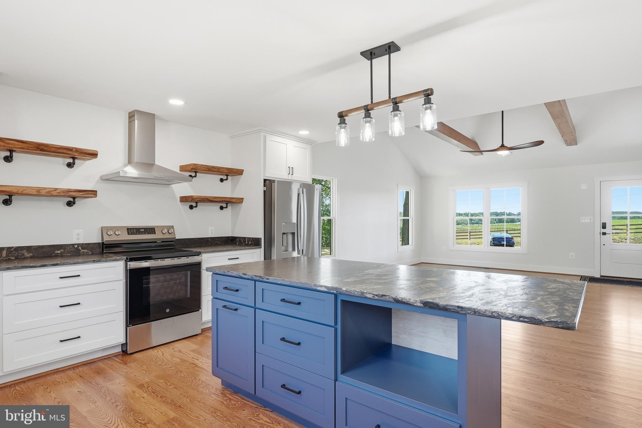 1548 James City Road Reva, VA 22735 - Photo 14 of 48 a kitchen with stainless steel appliances granite countertop a sink a stove and a wooden floors