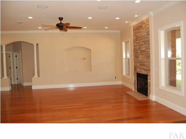6640 Codell Street Navarre, FL 32566 - Photo 7 of 22 LIVING ROOM FEATURES CEILING FAN, CROWN MOLDING, CUSTOM LIGHTING AND HARDWOOD FLOORING.