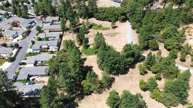 an aerial view of a house with a yard and lake view