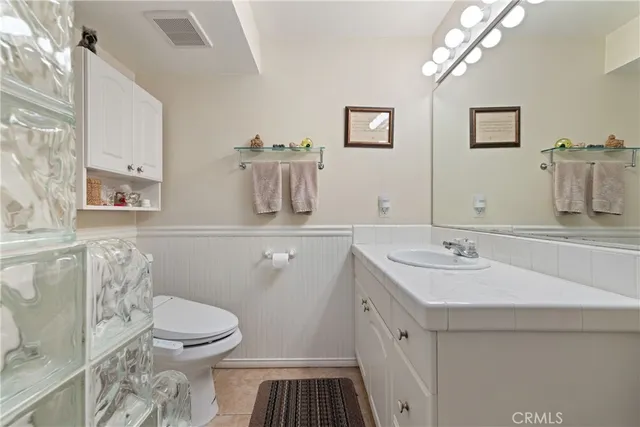 a bedroom with furniture and a fan