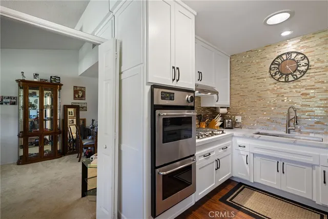 a view of a livingroom with workspace and a window